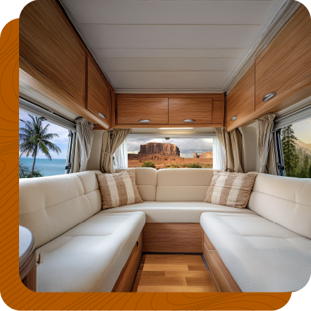 Seating area in recreational vehicle surrounds by large windows, curtains pushed back and large storage doors above. Seating area in recreational vehicle surrounds by large windows, curtains pushed back and large storage doors above.
