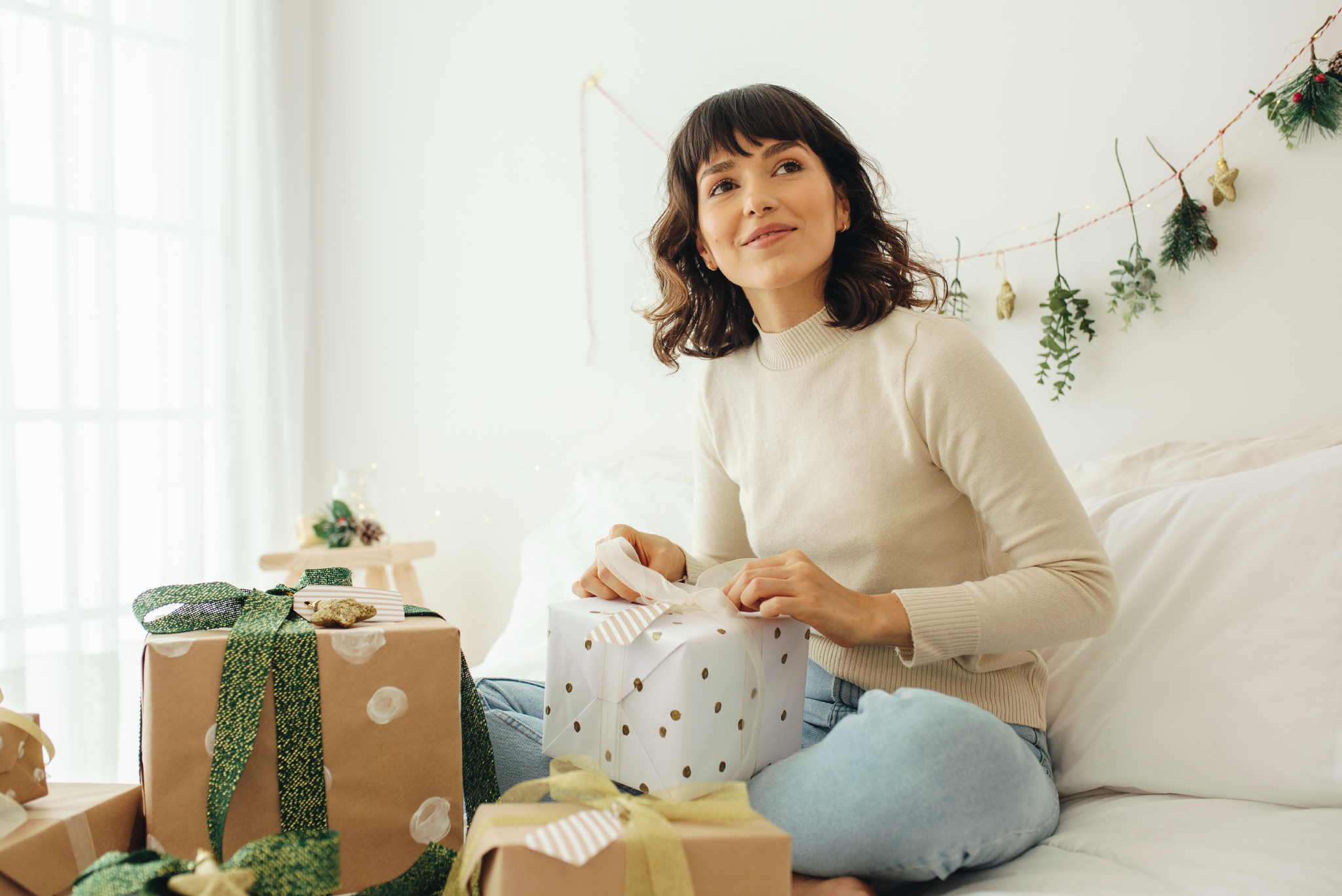 girl in a room wrapping presents cozy