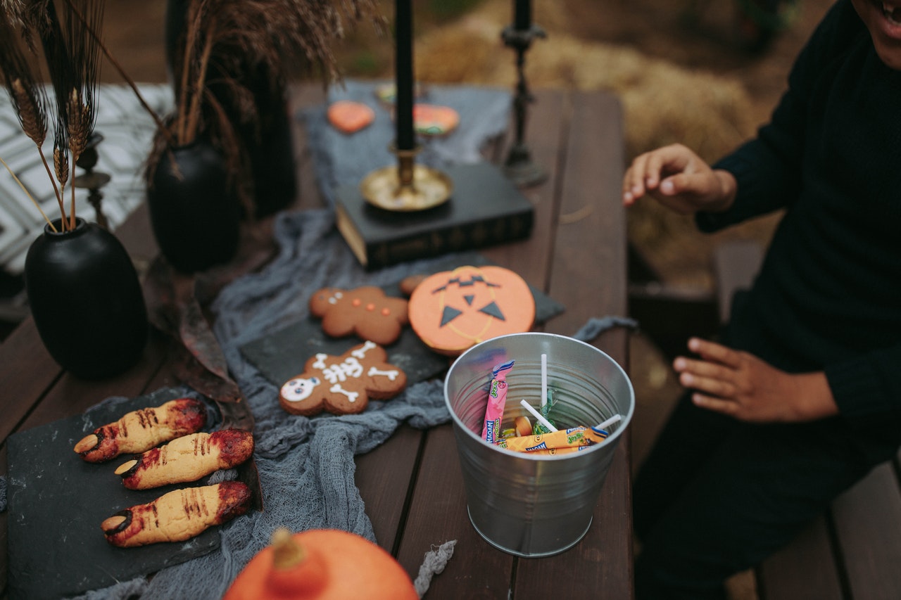 halloween table with candy and cookies for a halloween party