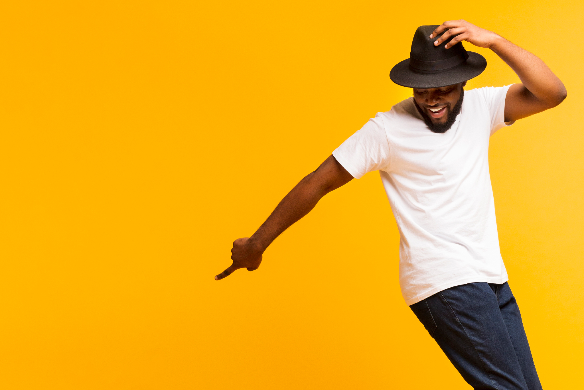 yellow background with person dancing in fedora
